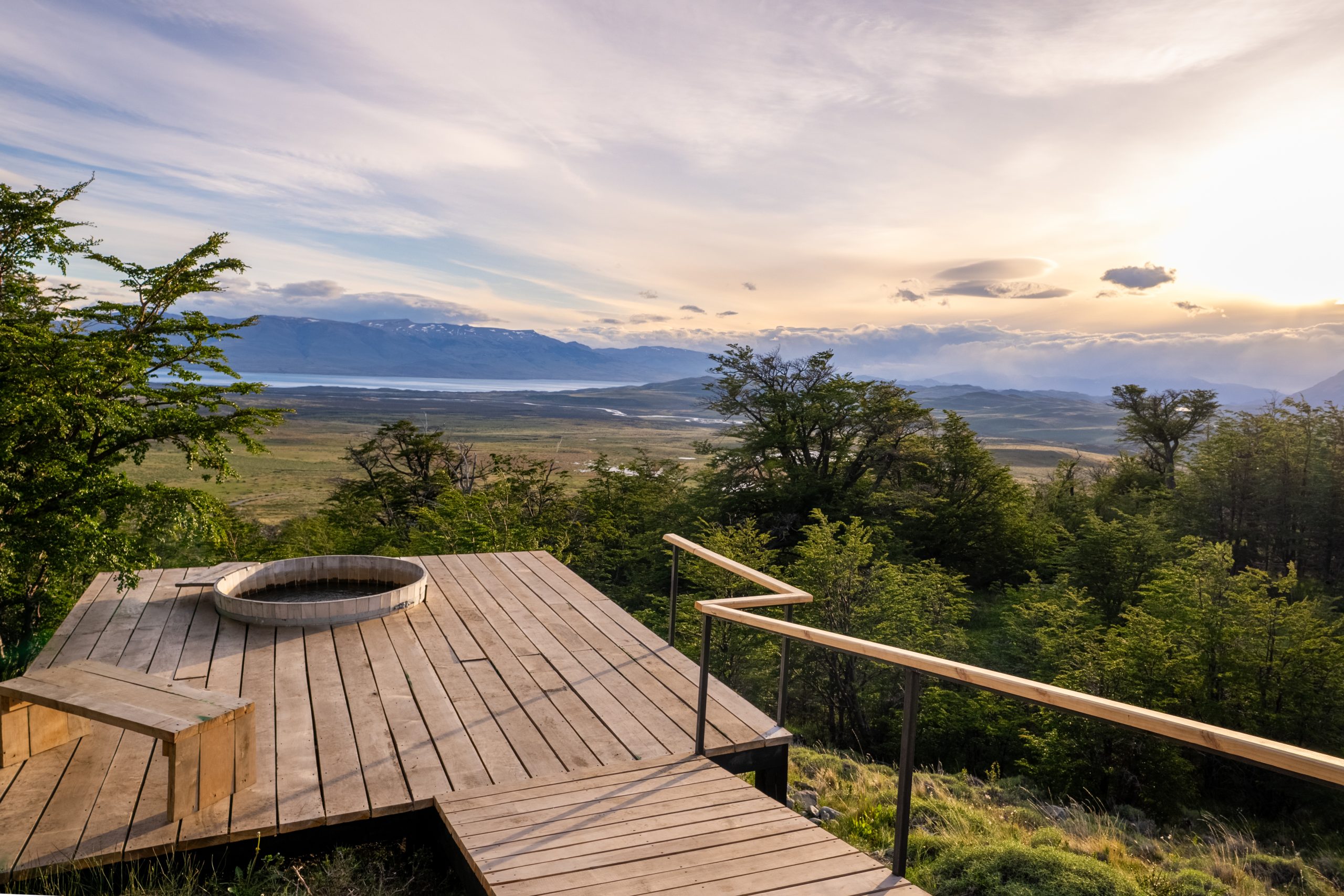 "Outdoor hot tub on a private villa terrace at Awasi Patagonia in Chile, crafted from local lenga and ñirre wood, offering sweeping views of Torres del Paine and Lake Sarmiento. The hot tub blends luxury with nature, surrounded by forest and the lodge’s private reserve setting.